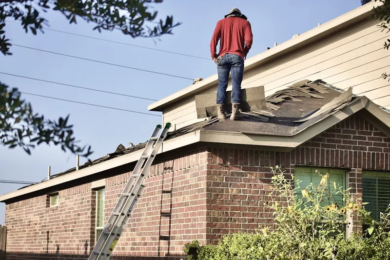 Professional roofer working on a residential roof in Bammel Timbers